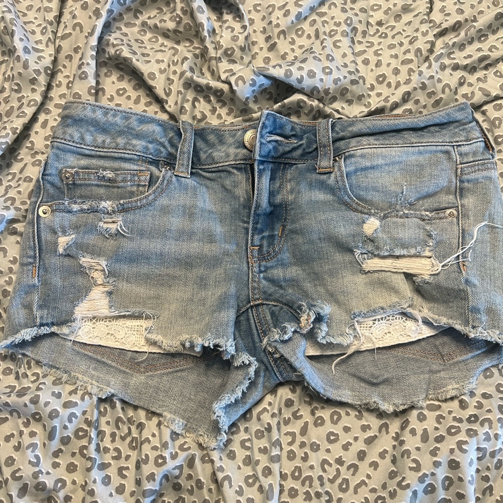 American Eagle super low shortie shorts with peek a boo lace pockets light blue